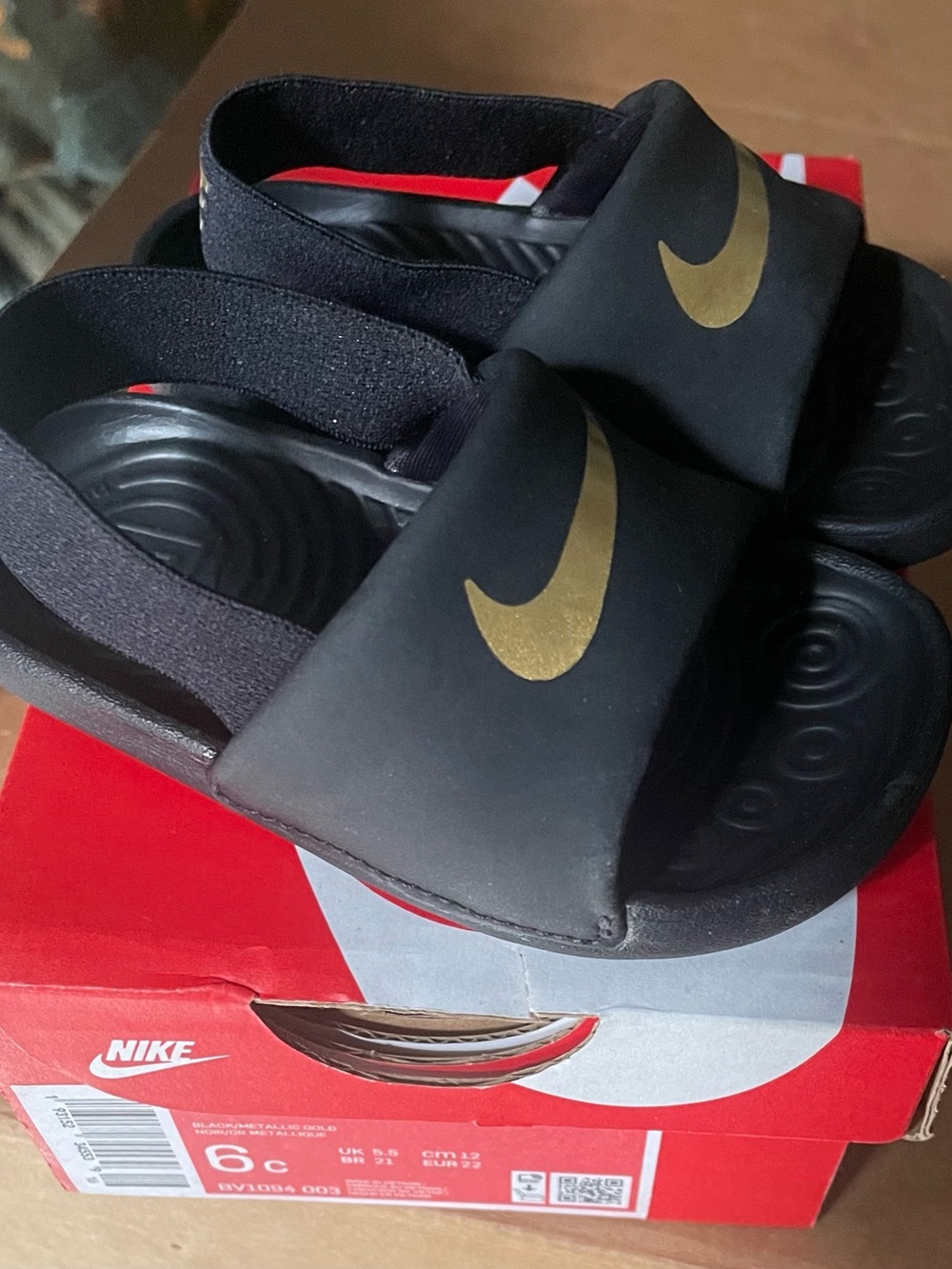 Nike Kids Black Slides with Gold Swoosh Accent